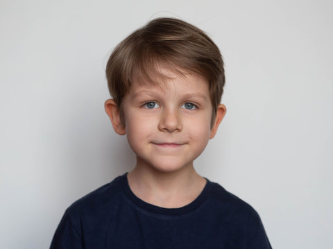 Portrait of a cute smiling preschooler boy on white background