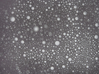 Abstract, decorative background, water drops on a multi-colored, blurred background of a cold tone, macro photography. Screen saver, artistic texture.