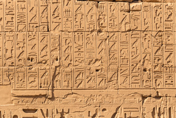 Fototapeta na wymiar Luxor Governorate, Egypt, Karnak Temple, complex of Amun-Re. Embossed hieroglyphics on columns and walls. The third pylon.