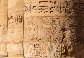 Karnak Temple, complex of Amun-Re. Great Hypostyle Hall. Embossed hieroglyphics on columns. Luxor Governorate, Egypt.