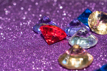 Multicolored decorative diamonds on a purple background
