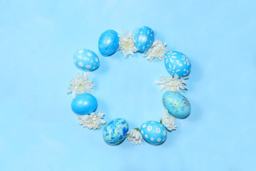 Decorated Easter eggs on a trendy blue background. Minimal holiday concept. Happy Easter background, greeting card, banner for the screen.