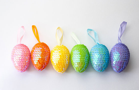 Colorful Easter eggs with sequins on ribbons