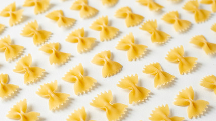Pasta, durum wheat pasta in the form of bows, food pattern, top view, copy space flat lay