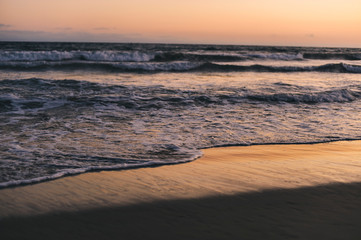 The ocean waves at dusk with view of the sand and red sky - Nature - Pacific