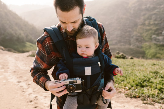 father traveling and hiking wiht his baby daughter  on the california coast