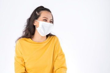 Young happy Asian woman wearing hygienic mask to prevent infection corona virus Air pollution pm2.5 she wearing a yellow sweater shoot in shot isolated on white background