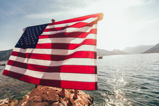 American flag in water with sexy women and man, independence day.