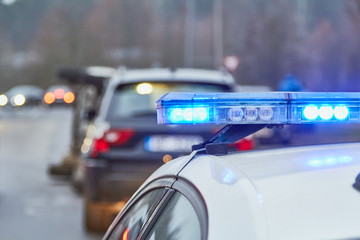 Obraz na płótnie Canvas Blue lights of a police car at the scene of an accident