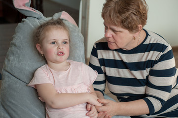 Grandmother 60 years old and granddaughter together at home. Take care of your family, stay home, coronovirus