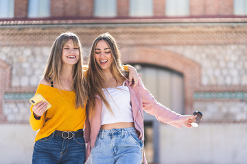 Two Teenage Spanish Girls Walking Together and Having fun Outdoors..