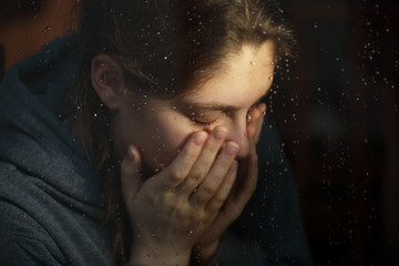 Young girl in home isolation, during quarantine for stave off preading of disease virus, near the...