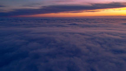 Above the clouds at sunset