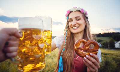 POV shot of couple in Bavaria toasting with beer