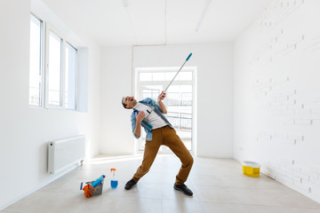 Obraz premium portrait of man with cleaning equipment cleaning the house