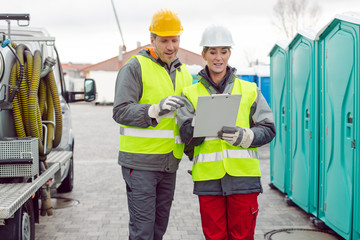 Workers doing some logistics in the rental toilet business