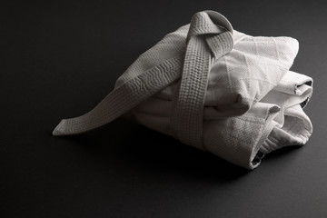 White judogi folded and tied with a white belt