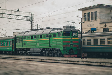 Ukrainian passenger train on the station of Zhmerynka during a small rain shower. Train waiting at the platform. Zhmerynka is an important rail junction in Ukraine