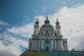Fototapeta na wymiar Beautiful orthodox church of St. Andrew in Kiev, Ukraine, on a summer day with some clouds. View from below.