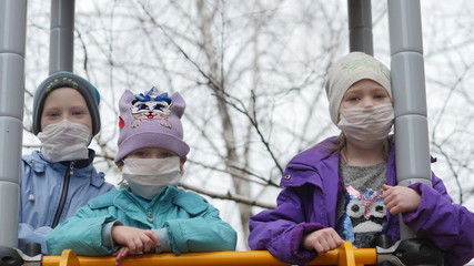 Children playing in the street in antiviral mask