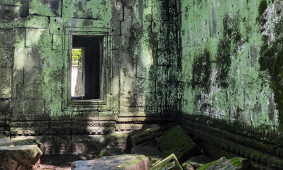 Old window on the ancient wall with moss, ruins, Angkor Wat temple, Siem Reap, Cambodia