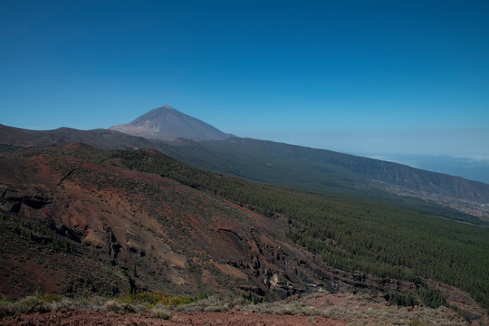 Mount Teide or Pico del Teide, the highest mountain in Spain, as seen from a viewpoint in the National Park, on TF-24 road heading up from the eastern part of the island, in Tenerife, Canary Islands