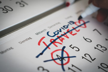 guy paints a mark on the calendar, due to coronavirus Concept of the raging coronavirus pandemic in...