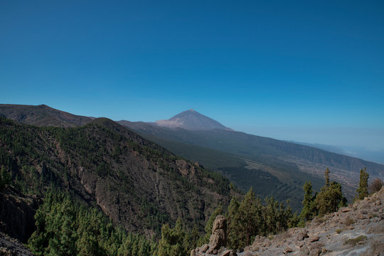 Mount Teide or Pico del Teide, the highest mountain in Spain, as seen from a viewpoint in the National Park, on TF-24 road heading up from the eastern part of the island, in Tenerife, Canary Islands