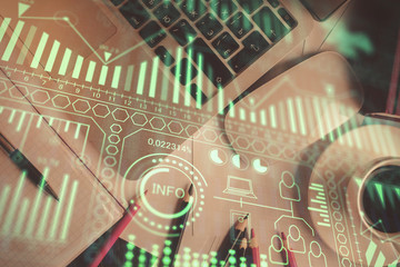 Technology hologram drawing over computer on the desktop background. Top view. Double exposure. Tech concept.