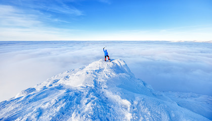 Epic scene of man at the summit of mountain as symbol of life success. Silhouette of man tourist...