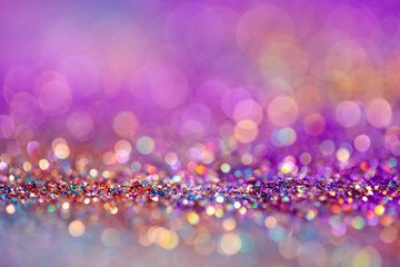 Festive twinkle lights background, abstract blurred backdrop with circles,modern design wallpaper with sparkling glimmers. Pink, purple and golden backdrop glittering sparks with blur effect