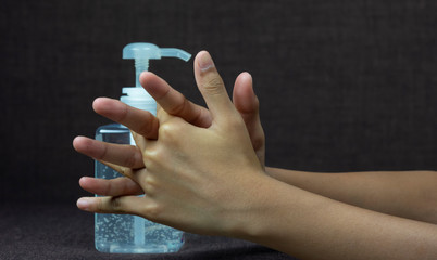 Child girl uses  hand sanitizer to clean her hand. Concepts of Flu virus, Covid-19 (Coronavirus disease). Can used for microbiology concept or medical healthcare.