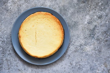 Classic New York cheesecake on a concrete background.