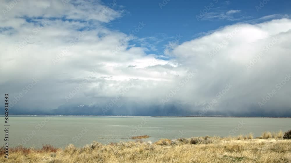 Canvas Prints low clouds moving over utah lake as it rains while the sun is shining.