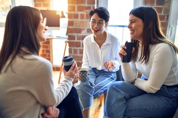 Beautiful businesswomen smiling happy. Sitting with smile on face speaking taking rest at the office