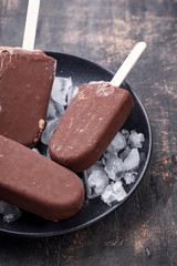 Chocolate ice cream popsicles in glaze