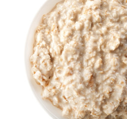 Bowl with tasty oatmeal on white background