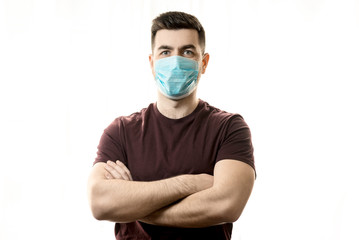 Theme of coronavirus and safety. A young man in a blue mask from a virus. Horizontal frame