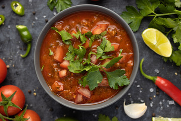 Traditional Latin American mexican salsa sauce and ingredients on stone table. Top view. Tomatoo sauce