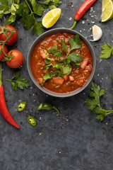 Traditional Latin American mexican salsa sauce and ingredients on stone table. Top view. Tomatoo sauce
