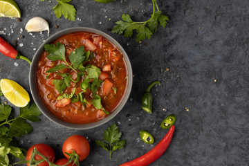 Traditional Latin American mexican salsa sauce and ingredients on stone table. Top view. Tomatoo sauce