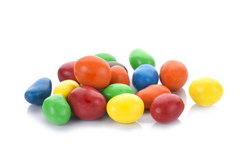 Colorful chocolate coated candies isolated on white background.