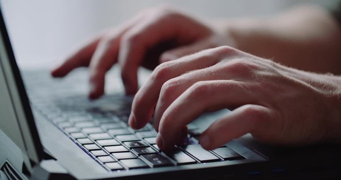 Business - Businessman hands type on laptop computer close up.