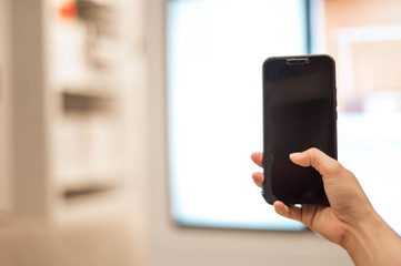 Woman hands holding smart phone with blank blank screen for text message or information content,