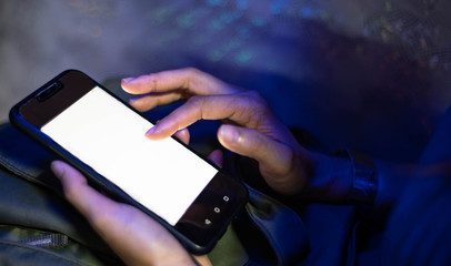 Woman hands holding smart phone with blank blank screen for text message or information content,
