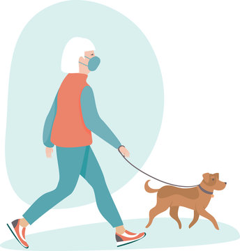 Senior woman wearing protective medical mask walking with her dog
