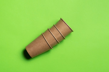 craft paper eco-friendly cups on a green background. eco friendly. isolate