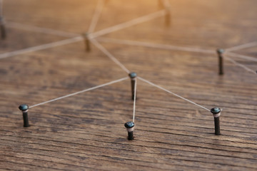 Network connection simulation with nails linked together by black cotton	
