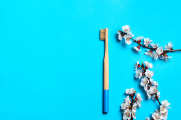 natural bamboo toothbrush on a blue background. Zero waste concept. Eco friendly. Flat lay, copy space