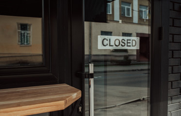 "Closed" message board on a cafe doors window. Economic crisis